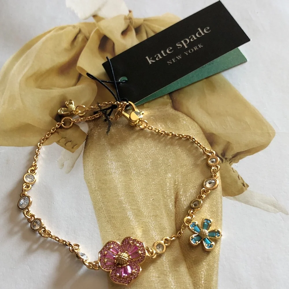 Authentic New with tag. kate spade Gold Bracelet with flower crystals.